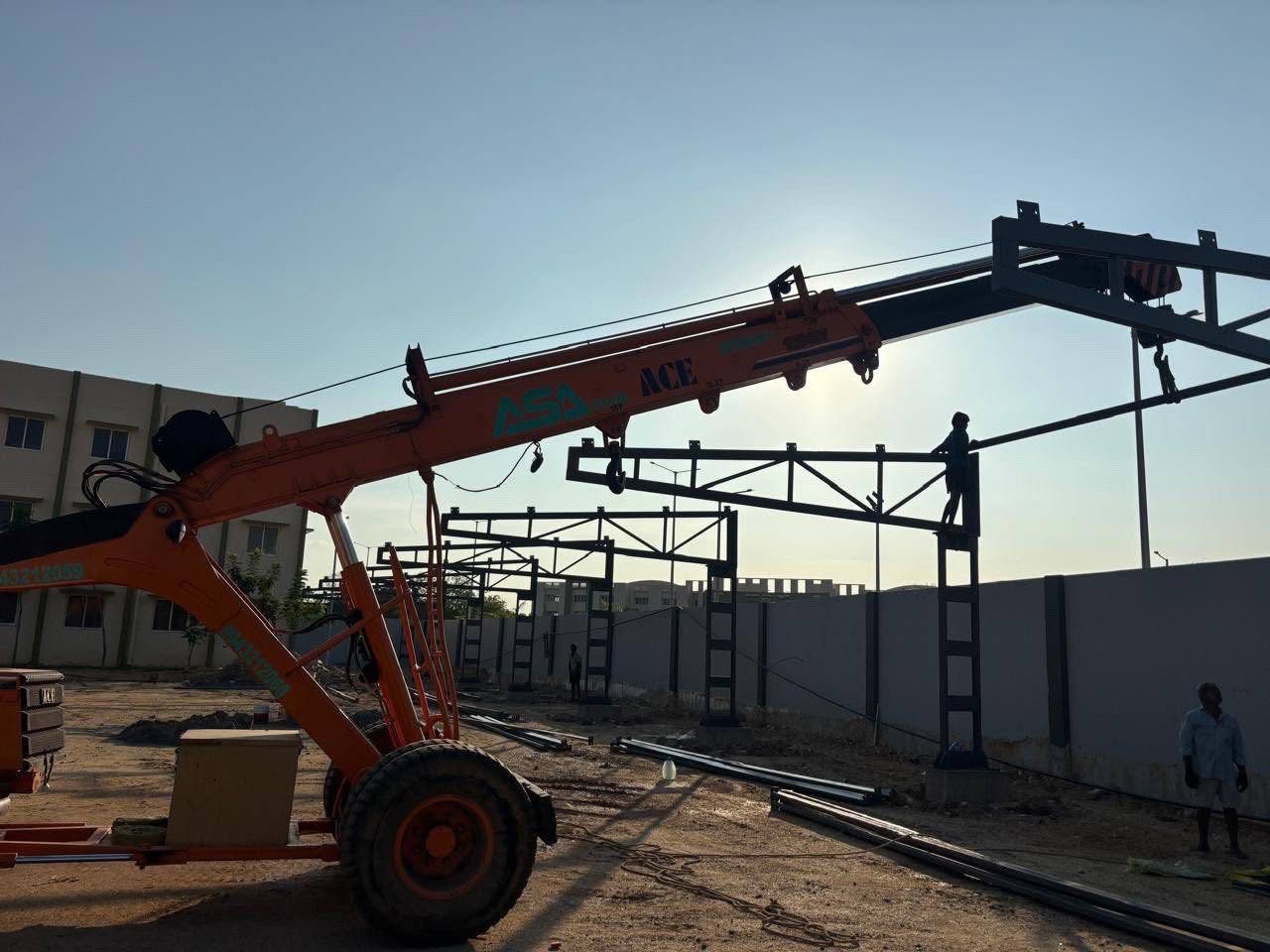 Sri Krishna Iron Works team erecting steel frames with a crane